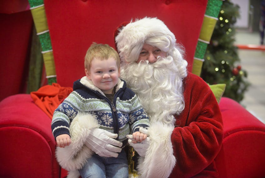 Henry Bryson meets Santa in the Charlottetown Mall Saturday as he and is parents, Matthew and Katherine, of Belfast, were getting in some last minute shopping. BRIAN MCINNIS/THE GUARDIAN