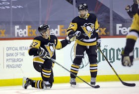 Pittsburgh Penguins’  Sidney Crosby (87) celebrates his goal with  Bryan Rust (17) against the Washington Capitals in the third period of an NHL game on Sunday. Crosby’s empty-net goal allowed him to pass Al MacInnis as the highest scoring Nova Scotia  player in NHL history. Charles LeClaire-USA TODAY Sports
