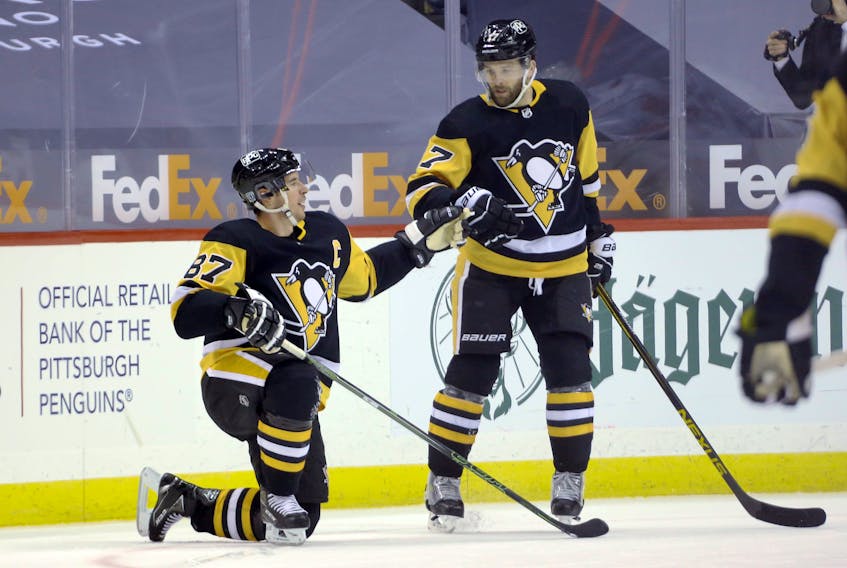 Pittsburgh Penguins’  Sidney Crosby (87) celebrates his goal with  Bryan Rust (17) against the Washington Capitals in the third period of an NHL game on Sunday. Crosby’s empty-net goal allowed him to pass Al MacInnis as the highest scoring Nova Scotia  player in NHL history. Charles LeClaire-USA TODAY Sports