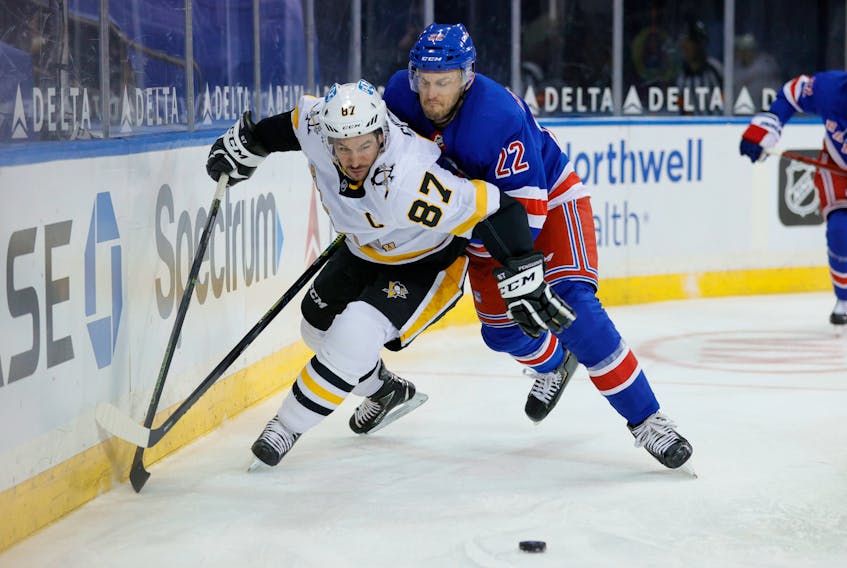 Sidney Crosby of the Pittsburgh Penguins battles Anthony Bitetto of the New York Rangers for the puck during an NHL game at Madison Square Garden on Febr. 01, 2021. (Sarah Stier/POOL PHOTOS-USA TODAY)
