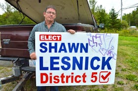Shawn Lesnick, District 5 candidate for the upcoming Cape Breton Regional Municipality election, holds one of his signs he found vandalized. Lesnick said he has found a sign in Wentworth creek and others have gone missing but he won’t let it get him down. Sharon Montgomery-Dupe/Cape Breton Post