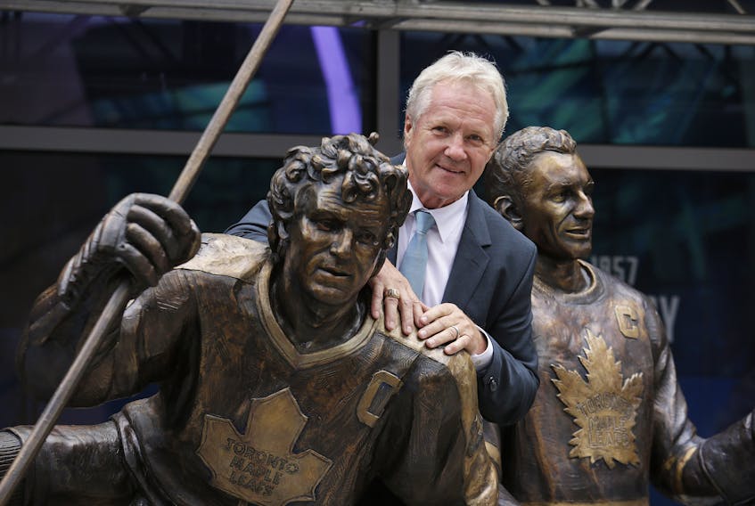Former Maple Leafs captain Darryl Sittler with his bronzed statue on Legends Row in front of Scotiabank Arena. Sittler, a veteran of many such series, figures three-game playoff sets might be the way to go if the NHL is able to complete its current season. (Craig Robertson/Toronto Sun)