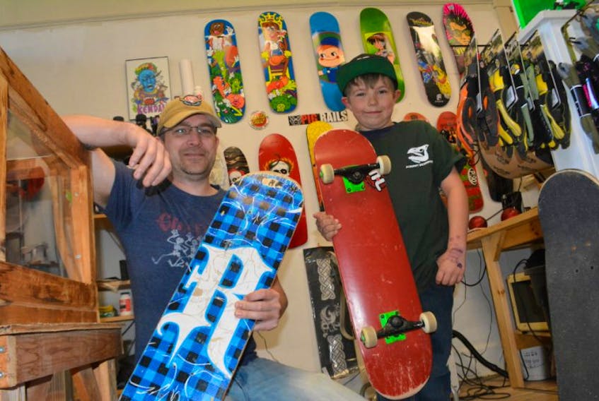 <p>James Hattie, the owner of Fishnet Sk8board Company, holds the old board that nine-year-old Lyndon Purdy had that was made out of cheap material. Hattie gave the youngster a maple skateboard for free, feeling the Purdy deserved a break to help him with his skateboarding. </p>
<p> </p>