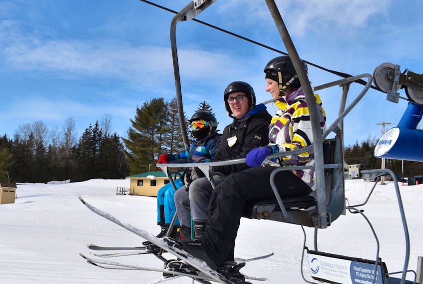 Skier Mitchell Perry, centre, rides the ski lift with educational assistant Michelle Gamble at Mark Arendz Provincial Ski Park at Brookvale March 12. Alison Jenkins/Journal Pioneer