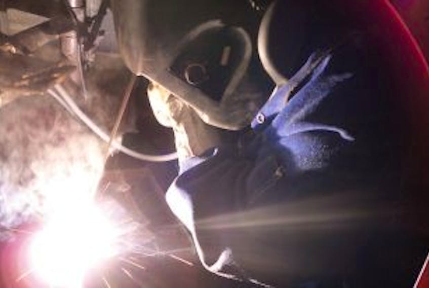 ['Nikki Huxter does an arc weld in the welding shop at Academy Canada. ']