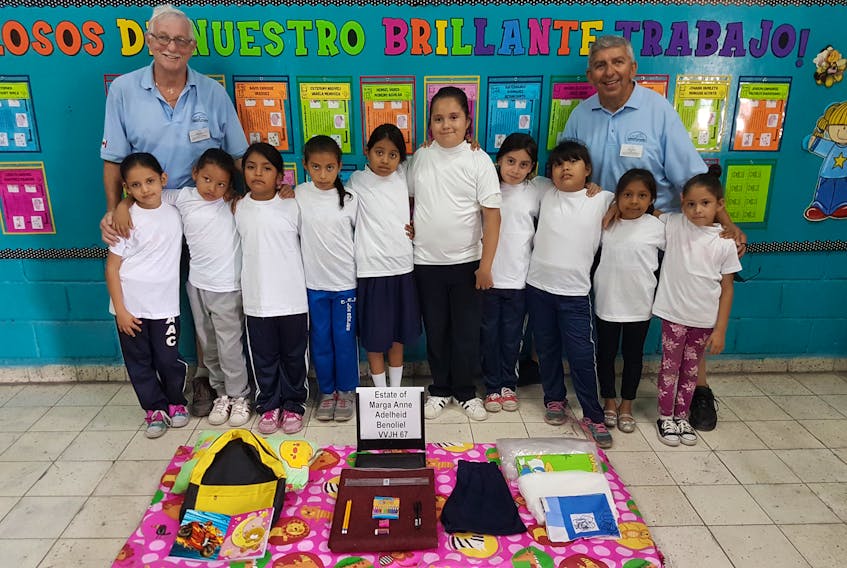 Connie Beaton and Clarence Deyoung with some of the children they met during a recent journey to Honduras, as volunteers with Sleeping Children Around the World (SCAW). Contributed