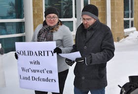 April Legge looks on as her partner Graham Downey-Sutton reads from a prepared speech during a demonstration in support of British Columbia’s Wet’suwet’en First Nation outside Corner Brook City Hall on Friday. Diane Crocker/The Western Star
