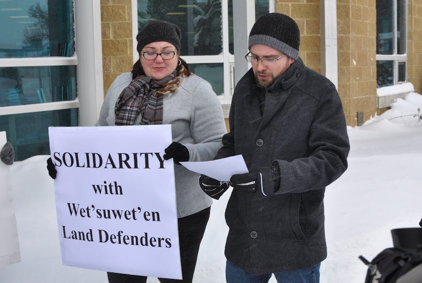April Legge looks on as her partner Graham Downey-Sutton reads from a prepared speech during a demonstration in support of British Columbia’s Wet’suwet’en First Nation outside Corner Brook City Hall on Friday. Diane Crocker/The Western Star
