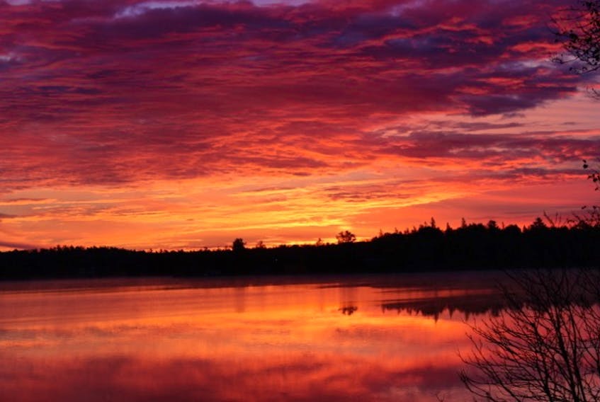 Grant Burnett captured the view as the rising sun painted a crimson sky over Lake Pleasant, Springfield, N.S.