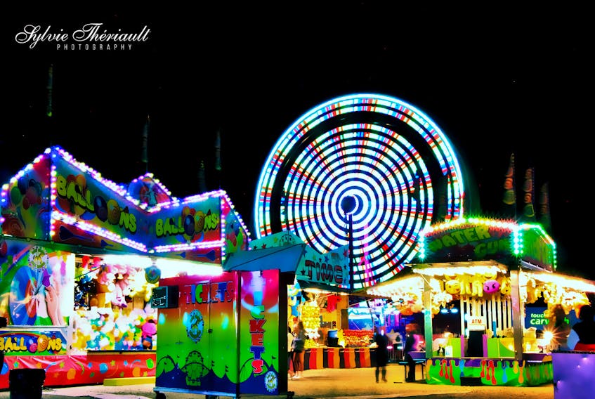 August: sunny days at the beach, the countdown to "back to school" and … the fair.  Across the region, amusement park rides and games are setting up shop.  Last Monday, Sylvie Theriault stopped by the fair on Main Street in Dartmouth, before it moved on to another city or town.  The vibrant lights made for a fabulous evening photo.