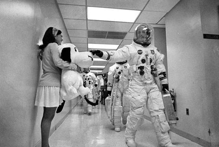Apollo 10 mission commander Thomas P. Stafford pats the nose of Snoopy, the mission’s mascot, on their way to the launching pad. - NASA