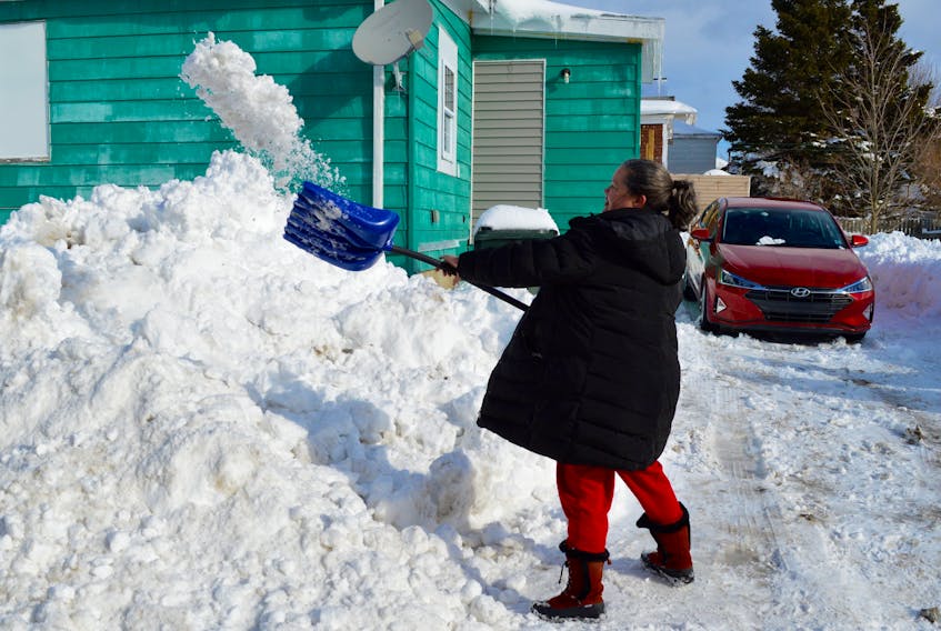 Nöel Daley shovels away the last of the snow from her Whitney Pier driveway early Monday afternoon. Daley, who was indeed born on Christmas Day, says she’s just about had enough of clearing the never-ending snow that has had Cape Bretoners shovelling out on a regular basis over the past month. David Jala/Cape Breton Post