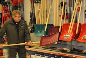 Rex Gibbons checks out a new shovel at Smith’s Home Hardware in the Village Shopping Centre in St. John’s Tuesday.  — Joe Gbbons/The Telegram


