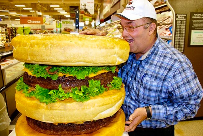 Brian Morrison, chairman of the P.E.I. Cattle Producers, hams it up with a giant, 150-pound hamburger made from Island beef.&amp;nbsp;