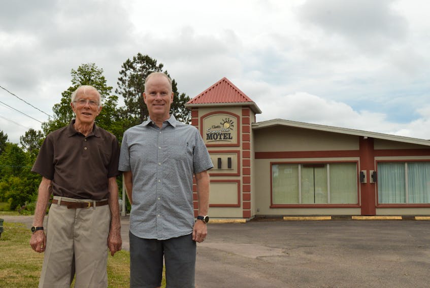 Brad Clark, left, and Myles Clark check on Clark's Sunny Isle Motel July 5. The summer of 2020 will be the first in 57 years that the motel has not opened.