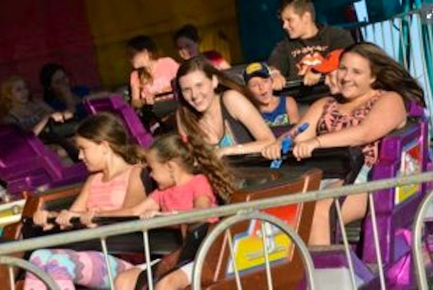 ['<p>Having fun on one of the midway rides at the Western Nova Scotia Exhibition in Yarmouth.<br />TINA COMEAU PHOTO</p>']