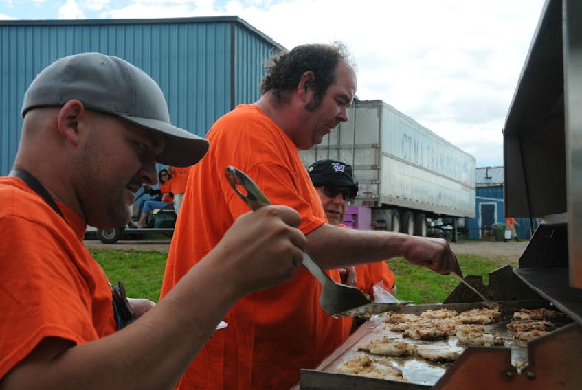 Village Feast volunteers help prepare the meal during a past year's event in Souris.