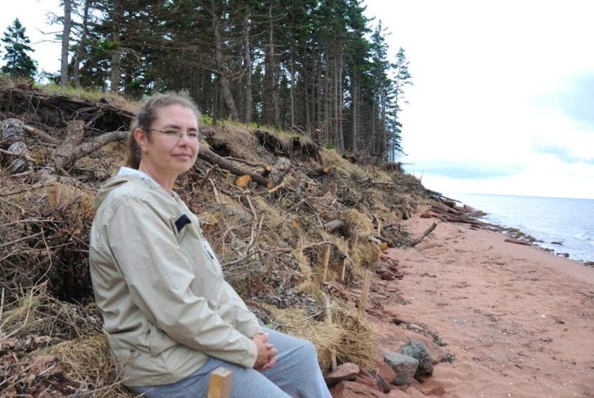 <p>Kellie Lockhart, manager of the South Shore Watershed Association, with the living shoreline her group recently built in Augustine Cove. The method is used as a long-term solution to coastal erosion.&nbsp;</p>