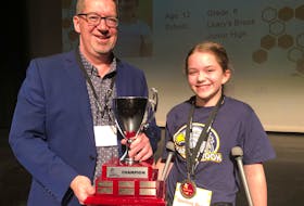 Leary’s Brook Junior High Grade 6 student Julia Evans is the 2020 Telegram Spelling Bee champion. Leo Gosse, The Telegram’s director of print sales and sponsorship, presents Julia with a trophy to display at her school. She also wins $2,000 and a berth in the Scripps National Spelling Bee in Washington, D.C, in May. See story on A7. JUANITA MERCER/THE TELEGRAM