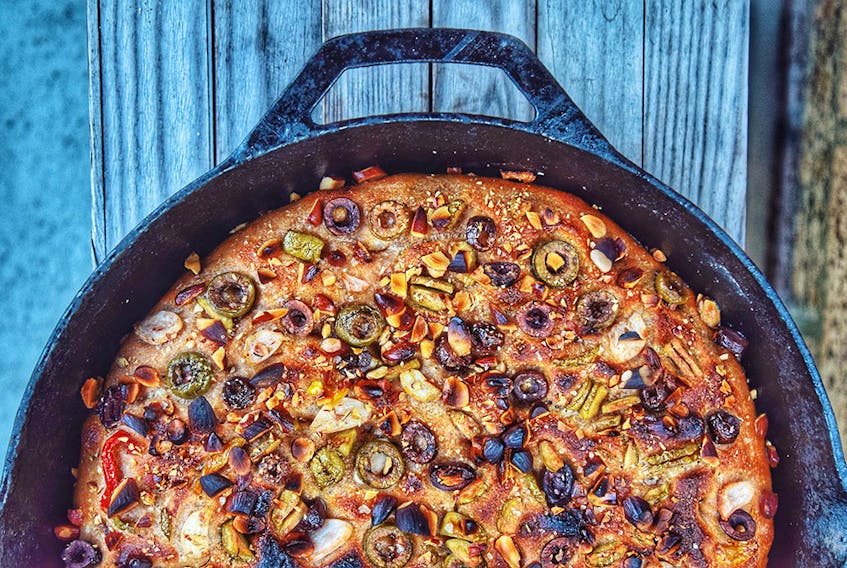 A yeasted spelt focaccia topped with olives, peppers, garlic and almonds. 
