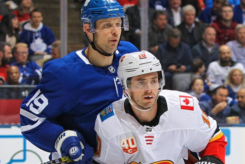 Calgary's Derek Ryan  battles Leafs' Jason Spezza Thursday night. (Getty images)