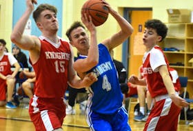 In this file photo, Adam Callaghan of the Sydney Academy Wildcats, middle, works his way to the rim as he's pressured by Millwood Knights players Morgan Rae, left, and Zach Duke during tournament play this past season. Callaghan is now a recruit of Mount Saint Vincent University. JEREMY FRASER/CAPE BRETON POST.