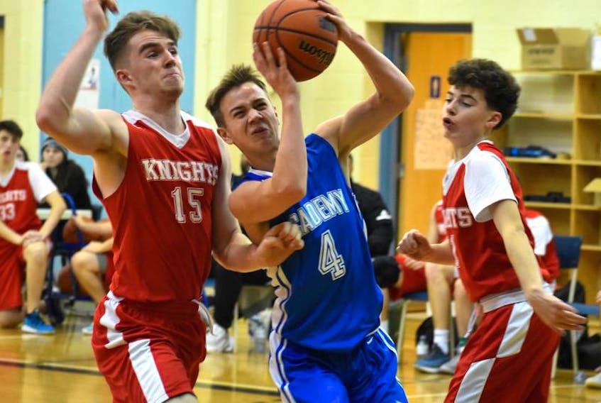 In this file photo, Adam Callaghan of the Sydney Academy Wildcats, middle, works his way to the rim as he's pressured by Millwood Knights players Morgan Rae, left, and Zach Duke during tournament play this past season. Callaghan is now a recruit of Mount Saint Vincent University. JEREMY FRASER/CAPE BRETON POST.