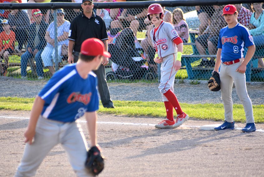 In this file photo, pitcher Ethan Lesieur of the Victoria Capitals watches Matthew MacDonald, middle, of the Cape Breton Ramblers closely as first baseman Seth Feldhuhn prepares for the throw over during Canadian Senior Little League Championship action at the Nicole Meaney Memorial Ball Park in Sydney Mines in July 2019. The 2021 national championship is slated for Sydney Mines in July. JEREMY FRASER/CAPE BRETON POST