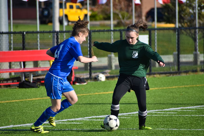 Marley MacGillivary of the Breton Education Centre Bears, right, protects the ball as Ella Greencorn pressures during Cape Breton High School Soccer League girls junior varsity action at Open Hearth Park in Sydney, in this file photo. An announcement on high school soccer has yet to be made, but with recent changes to COVID-19 guidelines, there's still hope for the soccer season. JEREMY FRASER • CAPE BRETON POST