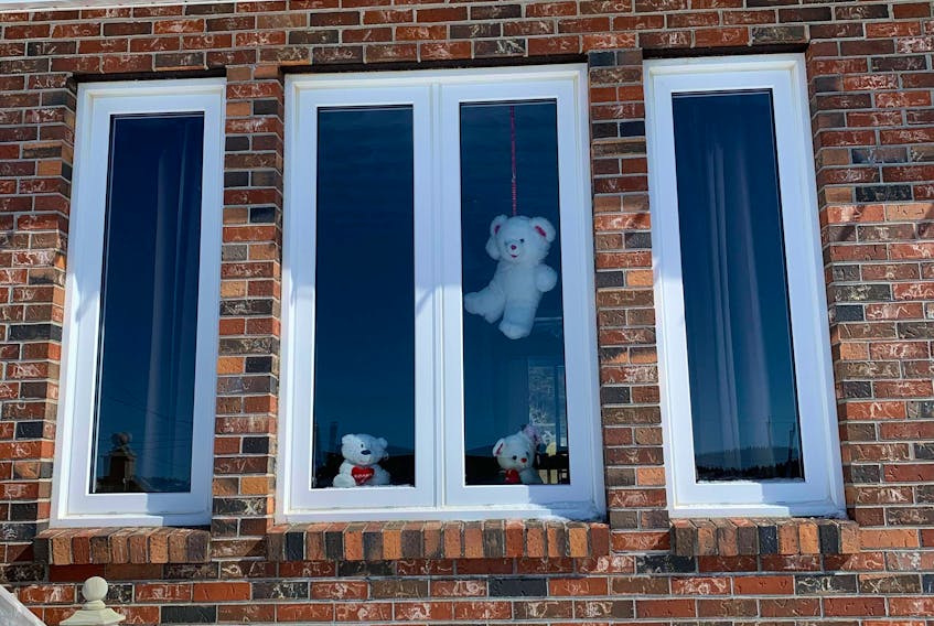 Bears hanging out in a window for the bear hunt in Port au Choix. 