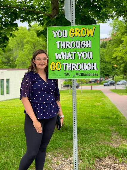 Corner Brook youth advisory committee member Maggie Hunt wants residents to see the positive message on signs the committee has placed throughout the city.