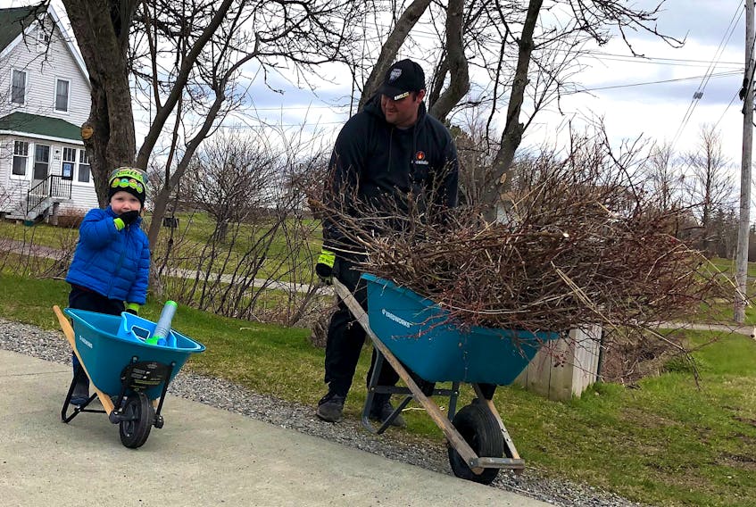 Everybody likes a little help with the yardwork. Jeremy MacDougall got some assistance with his spring cleaning around his Coxheath Road yard from his young son Easton on Thursday afternoon. The two were spotted hard at work picking up leaves, twigs and other yard scraps while sporting matching big and small wheelbarrows. GREG MCNEIL/CAPE BRETON POST