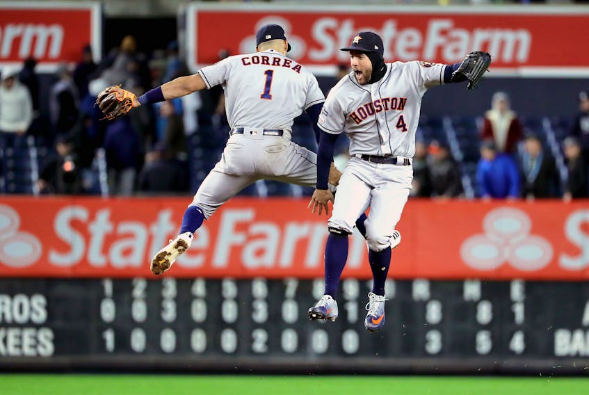 Astros' Carlos Correa (left) and George Springer celebrate their team's 8-3 win over the New York Yankees in Game 4 of the American League Championship Series at Yankee Stadium on Oct. 17, 2019 in New York City. (GETTY IMAGES)