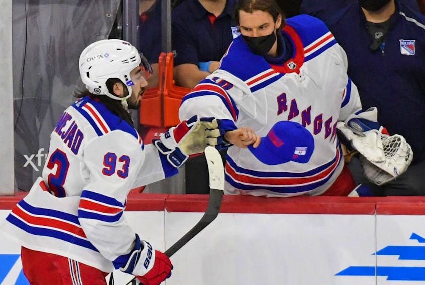 New York Rangers goaltender Alexandar Georgiev (40) tries to give centre Mika Zibanejad (93) a hat after he scored his third goal of the game against the Philadelphia Flyers on March 25, 2021.

