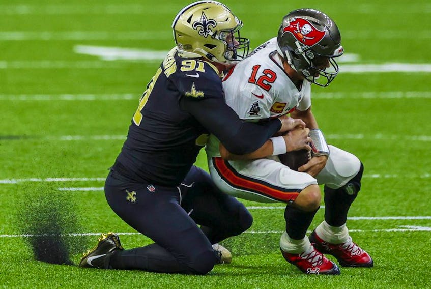 New Orleans Saints defensive end Trey Hendrickson (91) sacks Tampa Bay Buccaneers quarterback Tom Brady (12) during the second quarter at the Mercedes-Benz Superdome in New Orleans on Sept. 13, 2020.