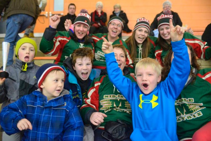 Fans of the Atom AAA Mid-Isle Matrix whoop it up in the stands as they cheer on their team against the Halifax Hawks in tgheir championship game in the 40th annual Spud minor Hockey tournament in MacLauchlan Arena Sunday. All their cheering and yelling paid off as the Matrix defeated the Hawks 4-2.