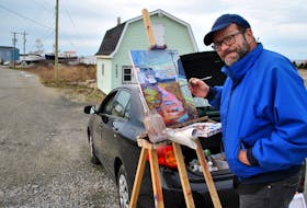 South Shore artist Andre Haines takes a quick break to look at the camera while painting on location in Woods Harbour in mid-December.  KATHY JOHNSON PHOTO