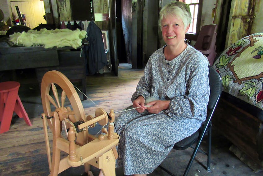 In period dress, Petra Fischer-Brunke demonstrates spinning at the Wile Carding Mill Museum in Bridgewater. A native of Hanover, Germany, Fischer-Brunke and her husband are seasonal residents at their home in Blockhouse. She says spinning is beneficial to people who struggle with stress and anxiety.