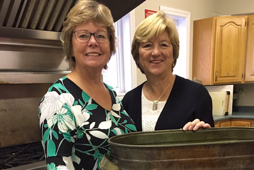 Jocelyn Wentzall, left, is the co-ordinator of the Christmas Pudding Factory, a popular fundraiser for Holy Trinity Anglican Church in Bridgewater, while Gillian Biddulph looks after sales. More than 65 church volunteers produce, wrap and sell between 1,450 and 1,600 lbs. of Christmas puddings.