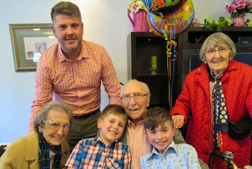Dennis Zwicker enjoys a 100th birthday moment with grandson Jonathan Stevens (back), sister Eleda Zwicker (left), great-grandsons Joseph and Stuart Stevens, and sister Deborah Zwicker.
