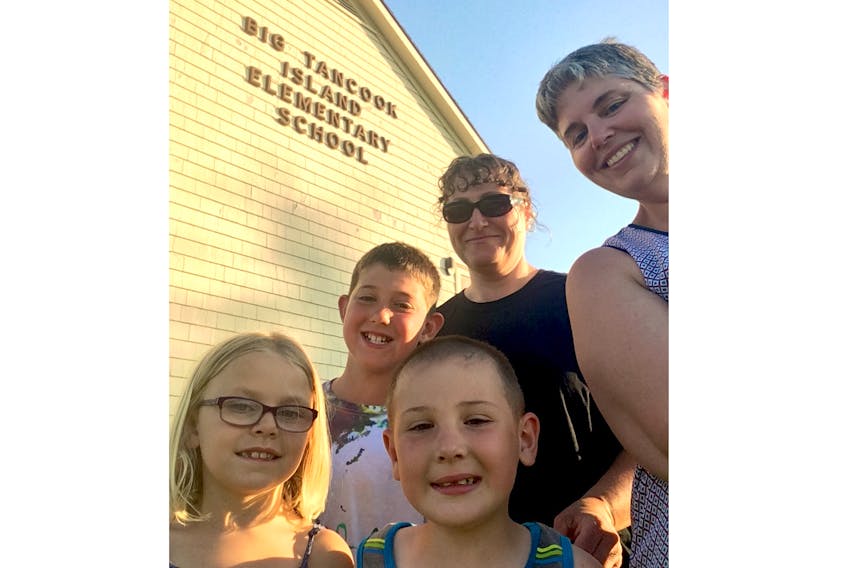 (Front) Half of Big Tancook students for this September: Felicity Zwicker, Josh Baker (back), William Westhaver with parents Laura Baker and Ann Westhaver.