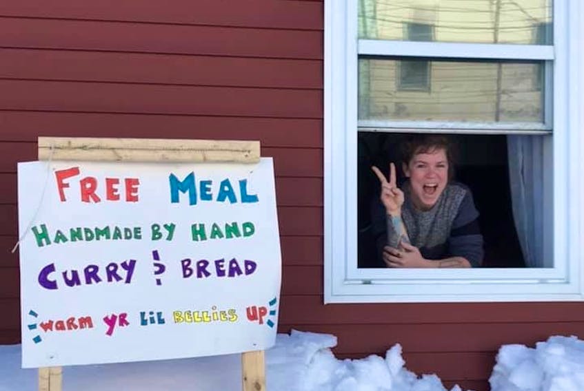 Chef Karen Willoughby sits at her downtown St. John's living room window — a.k.a. her temporary walk-thru window — from where she and friends served free meals of homemade vegetable curry and bread Thursday. CONTRIBUTED PHOTO


