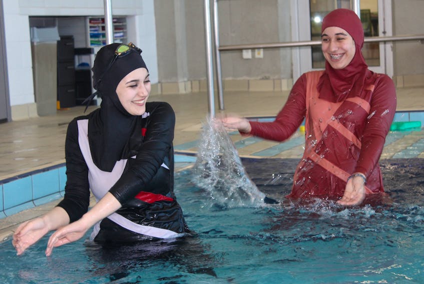Sulaf Alhraki and Fatimah Alaameri enjoy swimming in the new burkinis. JUANITA MERCER/THE TELEGRAM