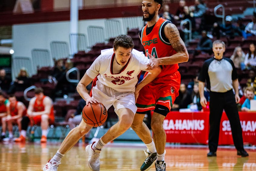 Cole Long (left) of the Memorial Sea-Hawks moves the ball upcourt against Paul Watson of the Cape Breton Capers in a weekend AUS men’s basketball game at the Field House in St. John’s. Long had a team-leading 26 points to lead Memorial to an 82-69 win over the Capers on Sunday. — Memorial Athletics photo/Ally Wragg
