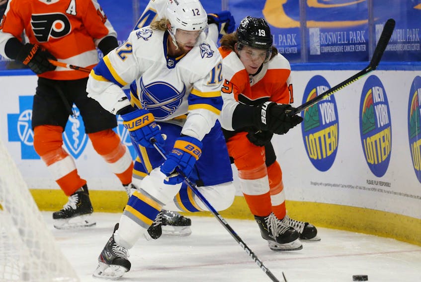 Buffalo Sabres forward Eric Staal (12) works for the puck during a game against the Philadelphia Flyers on Feb. 28. Why does Staal, traded from Buffalo to Montreal, only have to do a seven-day quarantine while ordinary Canadians still have to do 14?