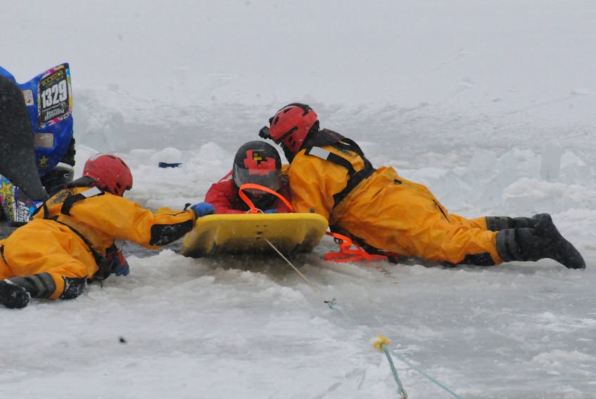 Conception Bay South Fire Department firefighter Jeremy McDonald (left) and F/Lieut. Andre Whitty pull “victim” Jack Hickey onto a board and haul him out of the water during a training exercise Wednesday. Joe Gibbons/The Telegram