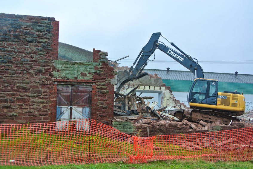 Amherst has stopped the demolition of a building on Station Street following the discovery of approximately 20 cans of what appears to be camping fuel.
