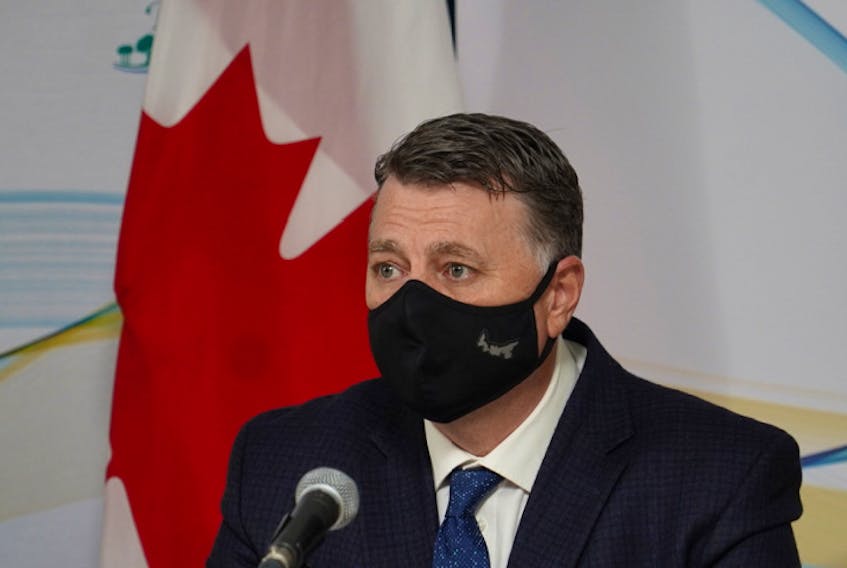 P.E.I. premier Dennis King dons a mask for a media briefing Tuesday, Nov. 17. Masks will be mandatory in public spaces on P.E.I. starting Friday, Nov. 20.