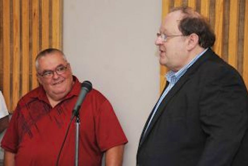 ['Premier Tom Marshall, right, flanked to the left by Steady Brook Mayor Peter Rowsell, announces $1.6 million for a new municipal building to house Steady Brook’s fire hall and maintenance garage Monday, June 30, 2014.']