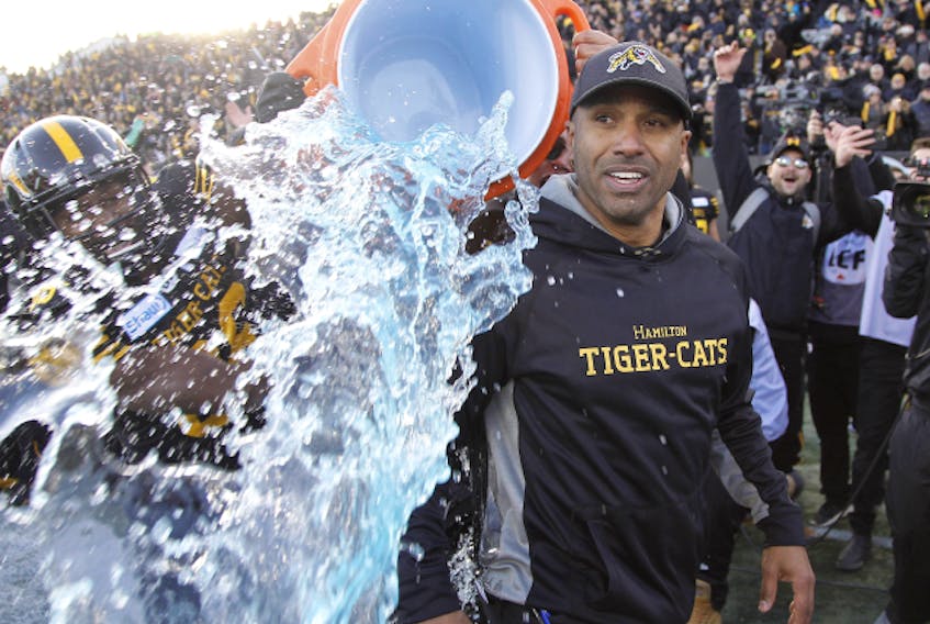 Hamilton Tiger-Cats head coach Orlondo Steinauer gets doused with ice water after defeating the Edmonton Eskimos during the East final at Tim Hortons Field. (John E. Sokolowski-USA TODAY Sports)